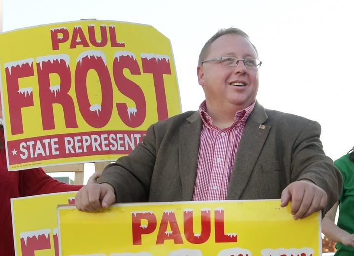 Rep. Paul Frost holding campaign signs